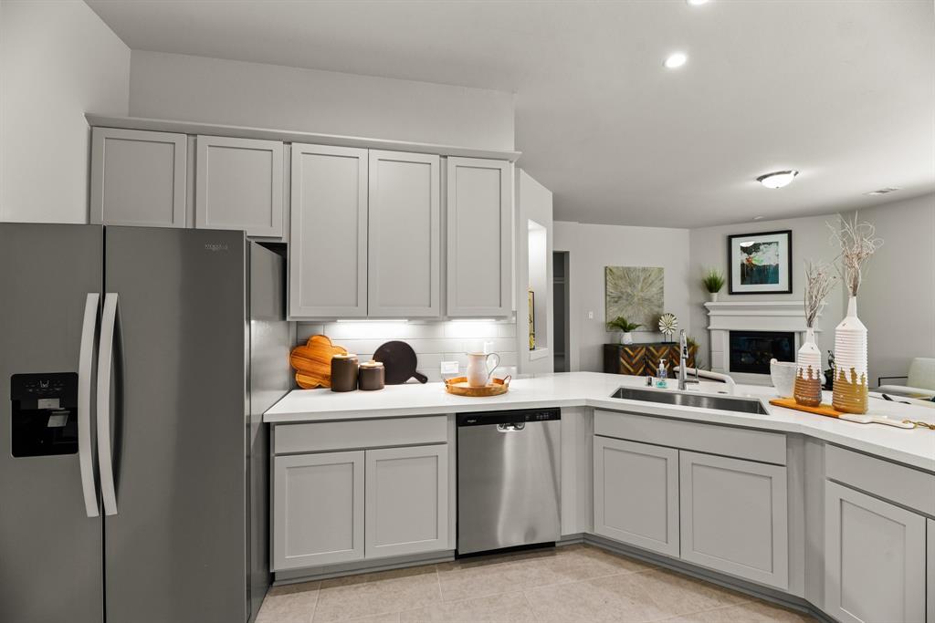 A kitchen with white cabinets.