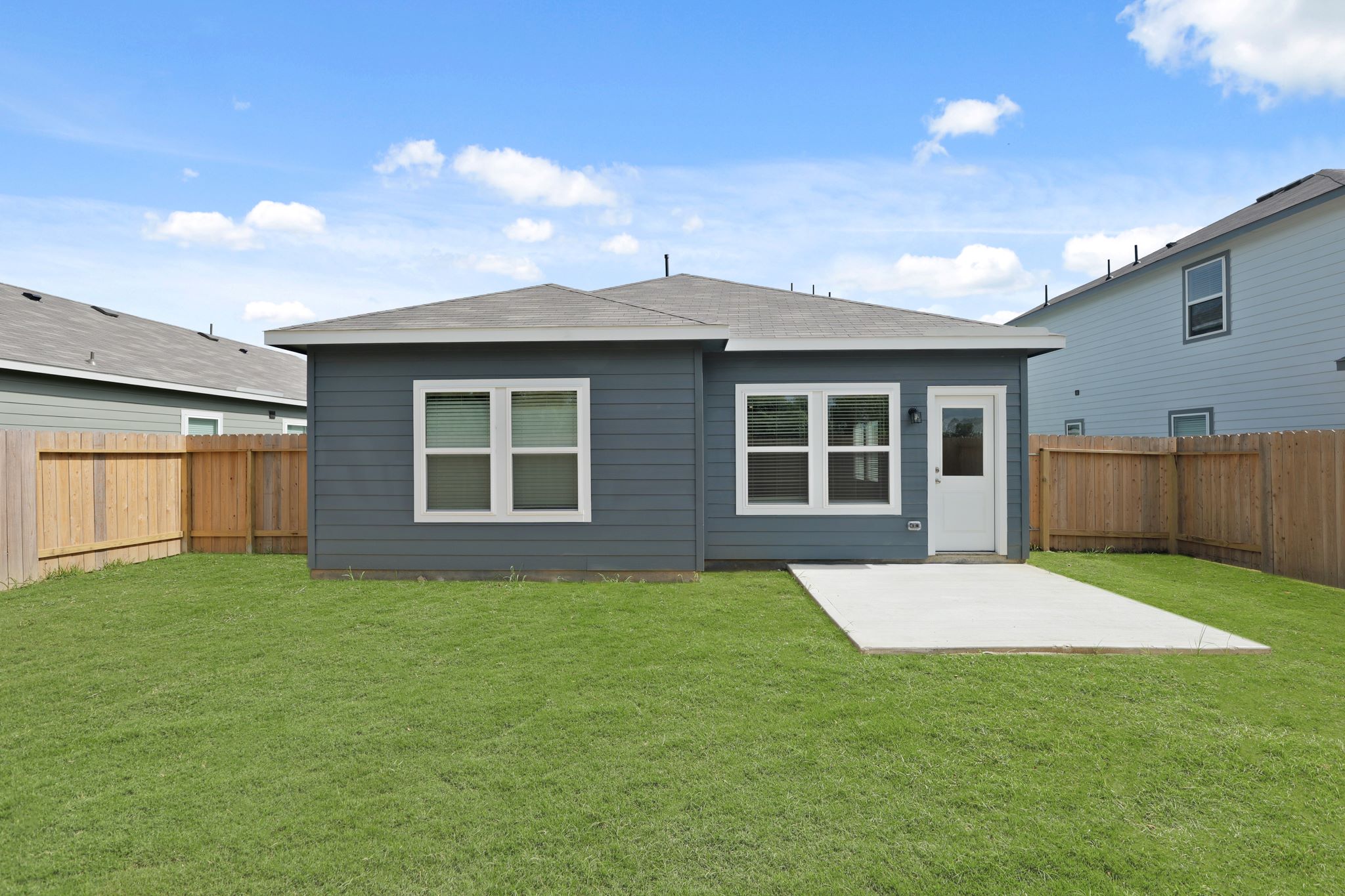 A house with a fence and grass.