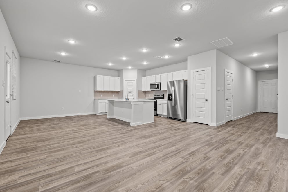 A kitchen with white cabinets.