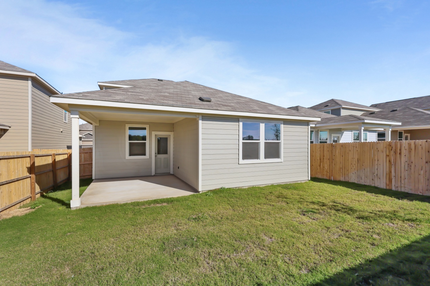 A house with a fence and grass.