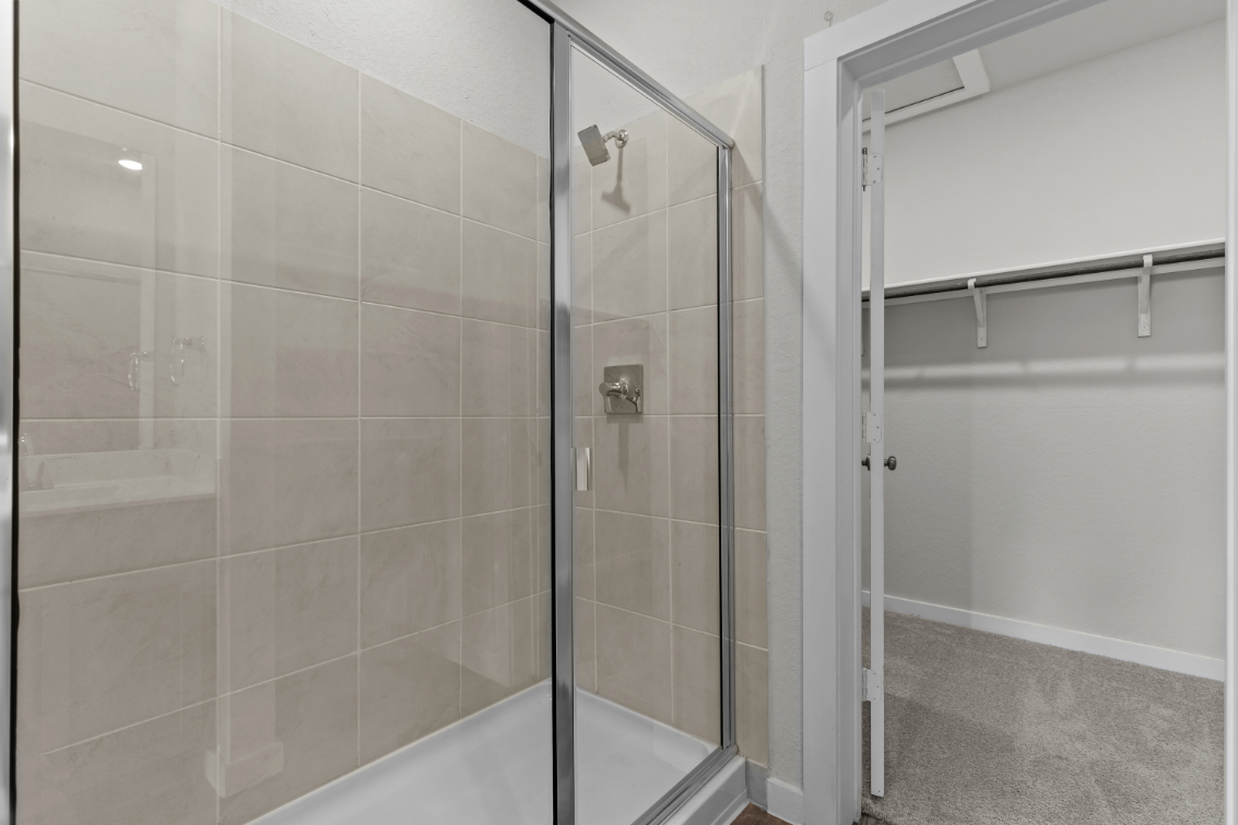 A shower with a glass door.