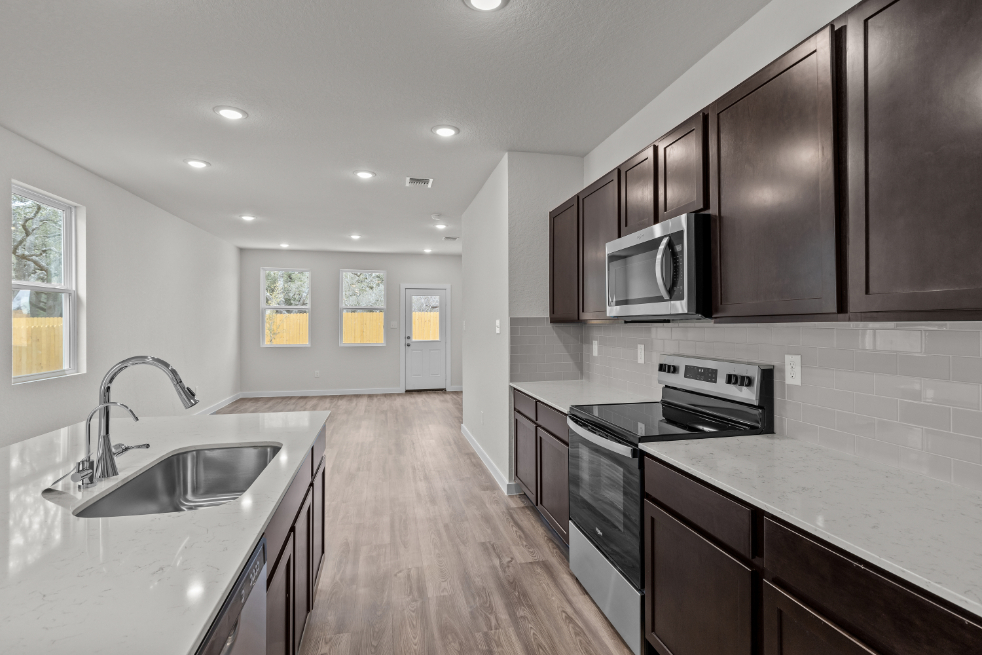 A kitchen with black cabinets.