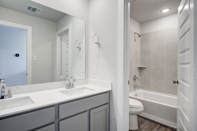 A bathroom with a tub sink and toilet.