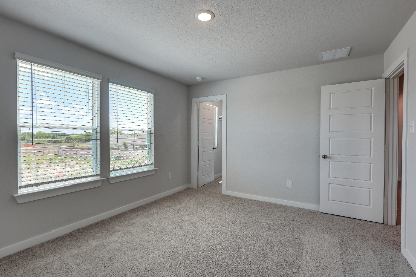 A room with a window and a door.