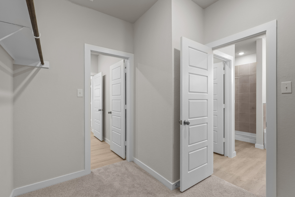 A hallway with white doors.