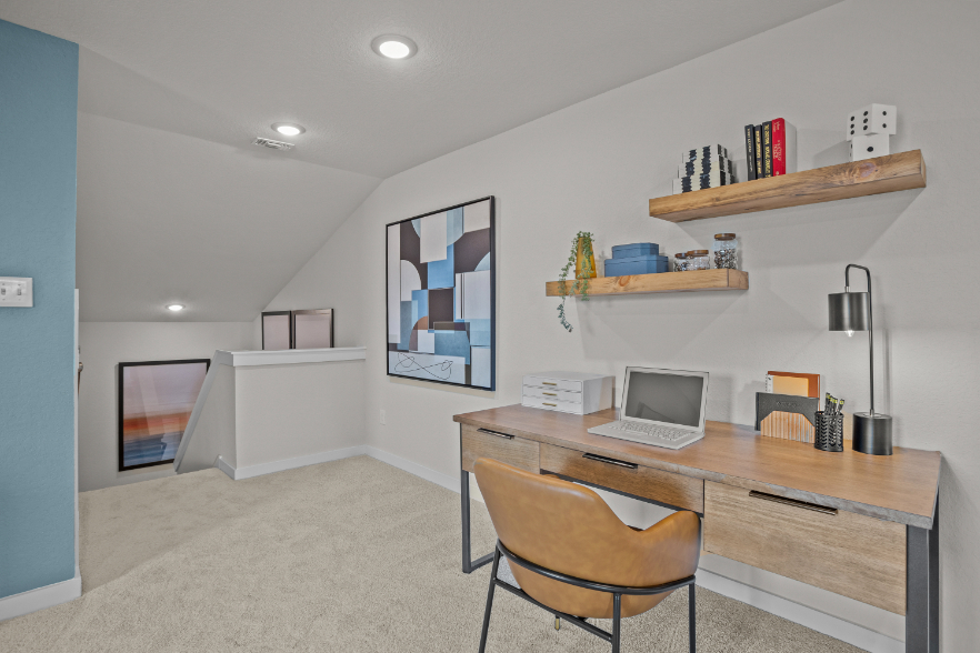 A desk with a laptop on it.