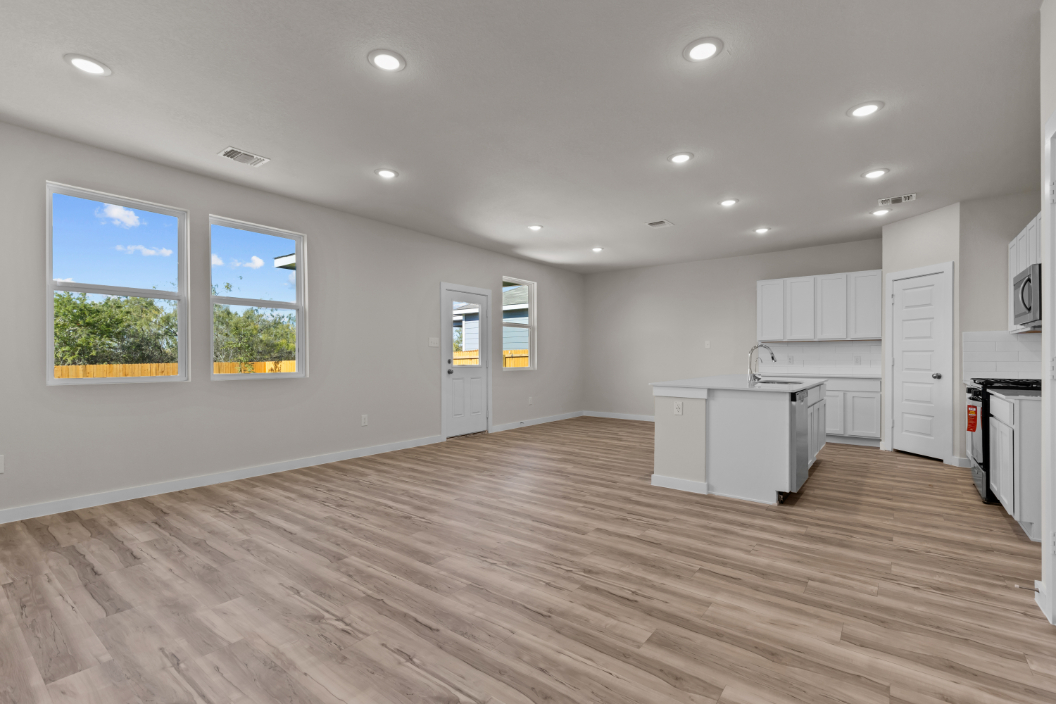 A kitchen with white cabinets.