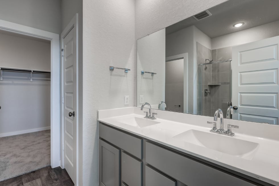 A bathroom with a large mirror.