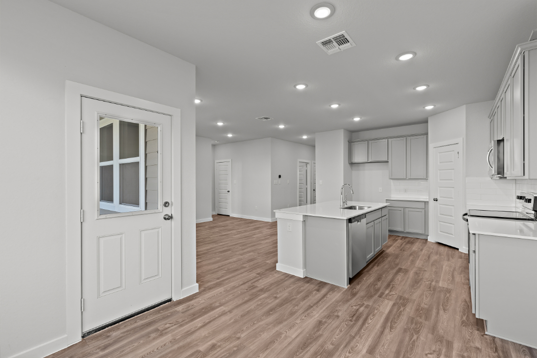 A kitchen with white cabinets.