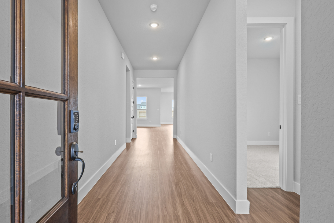 A hallway with white walls.