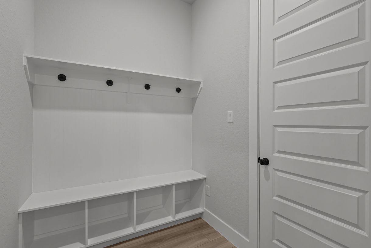 A white cabinet with a white door.