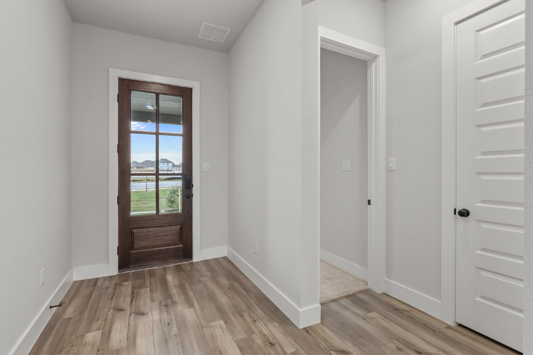 A room with white walls and a wood floor.