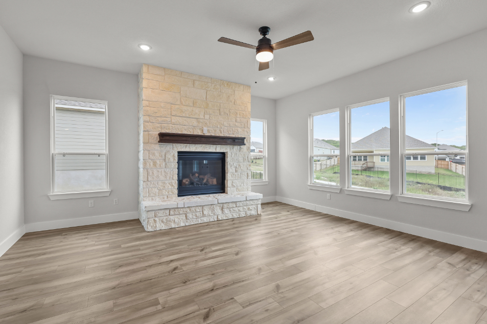 A room with a fireplace and a wood floor.