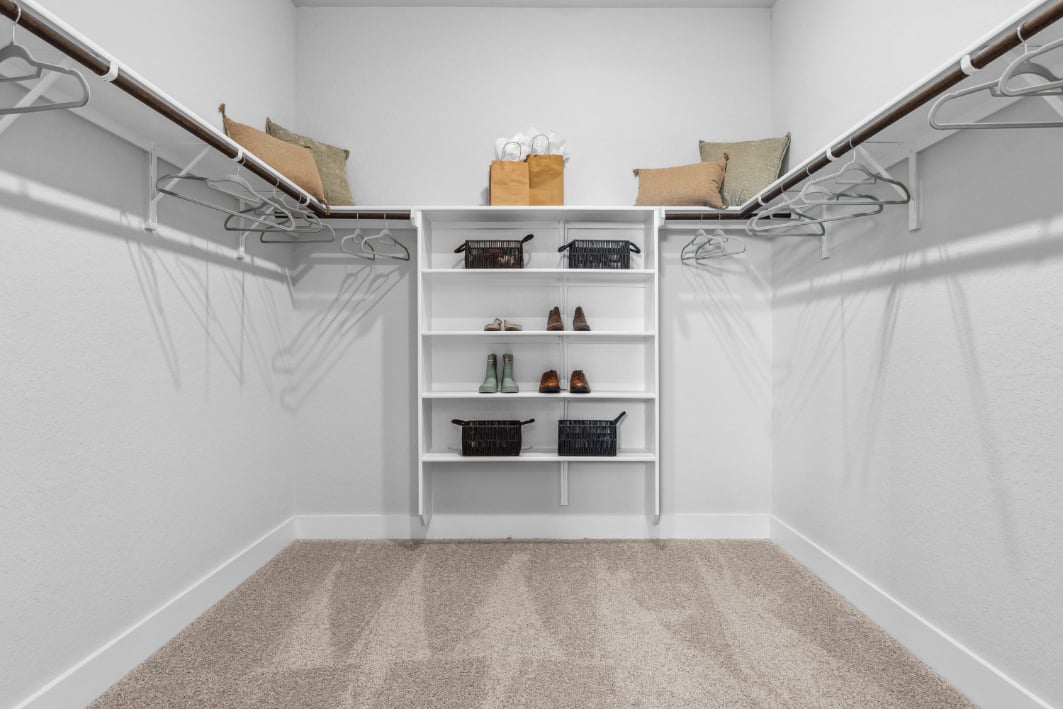 A white room with shelves and a white wall.