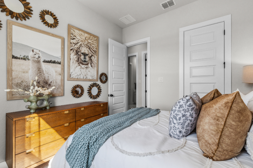 A bed with a blue blanket.