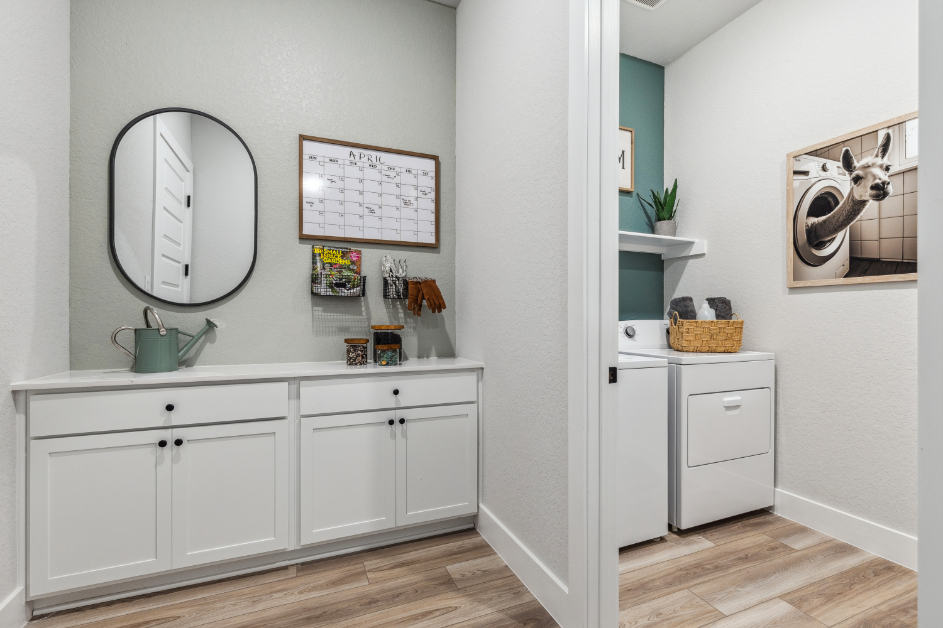 A white kitchen with a mirror.
