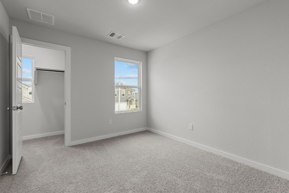 A room with a window and a door.