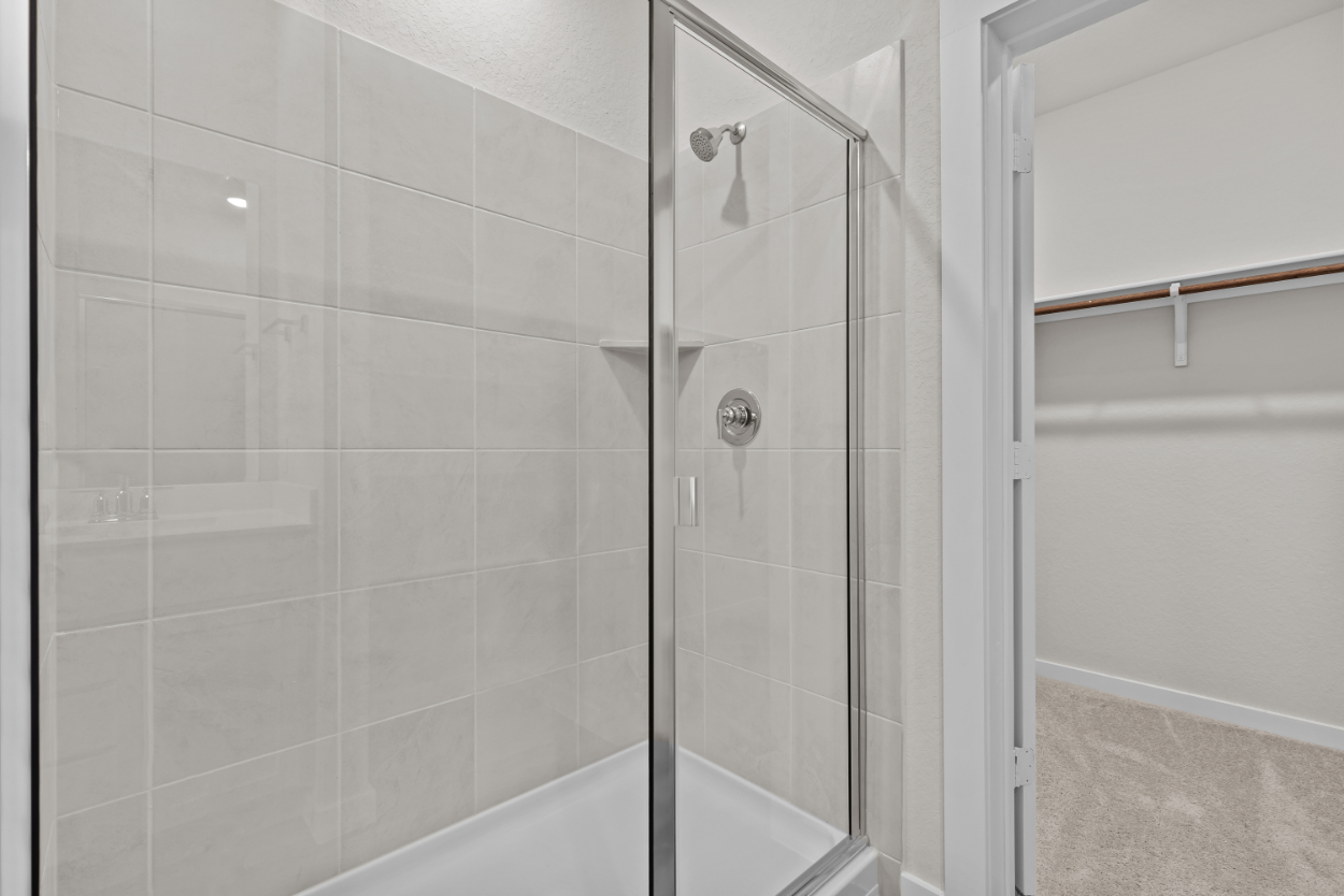 A shower with a glass door.