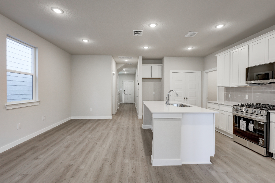 A kitchen with white cabinets.