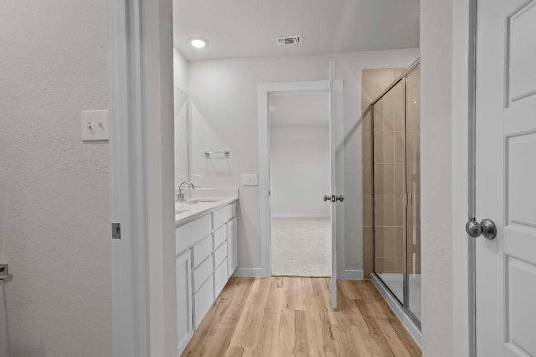 A bathroom with a shower and a sink.