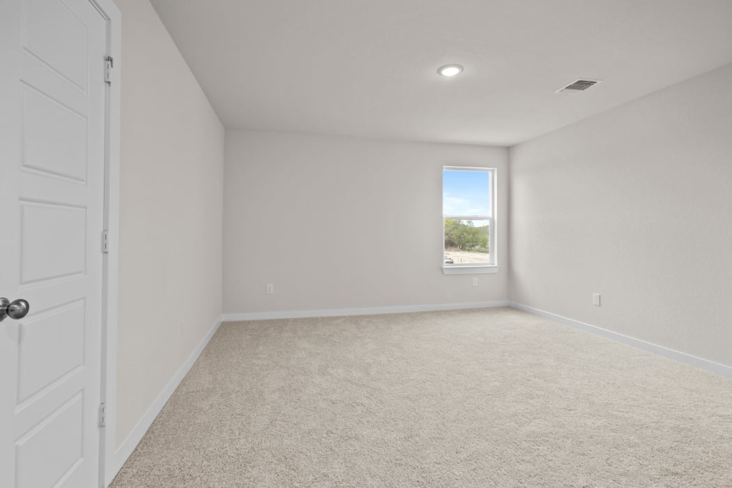 A room with a window and carpet.