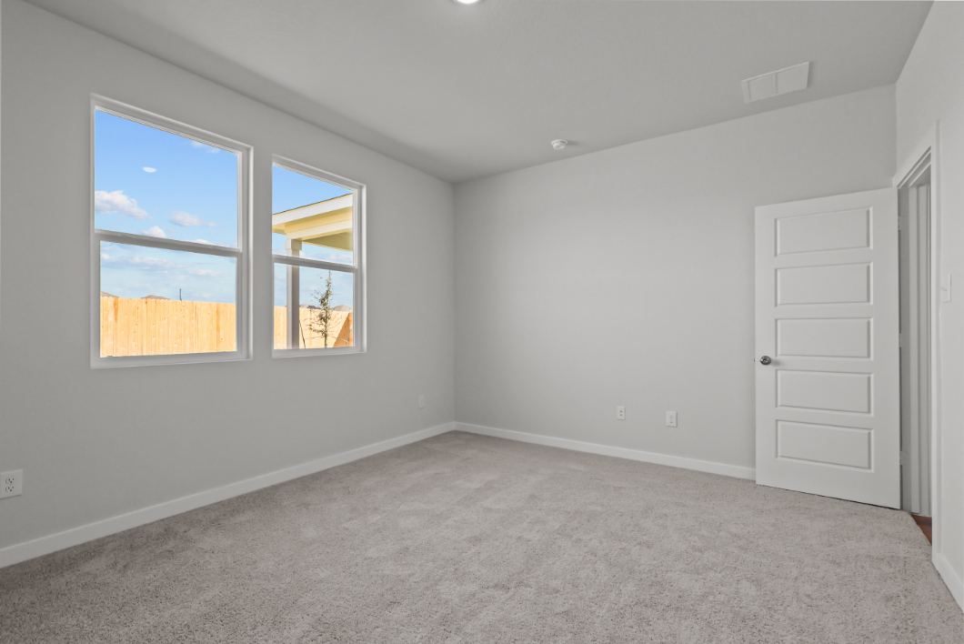 A room with a window and a door with a view of the sun.