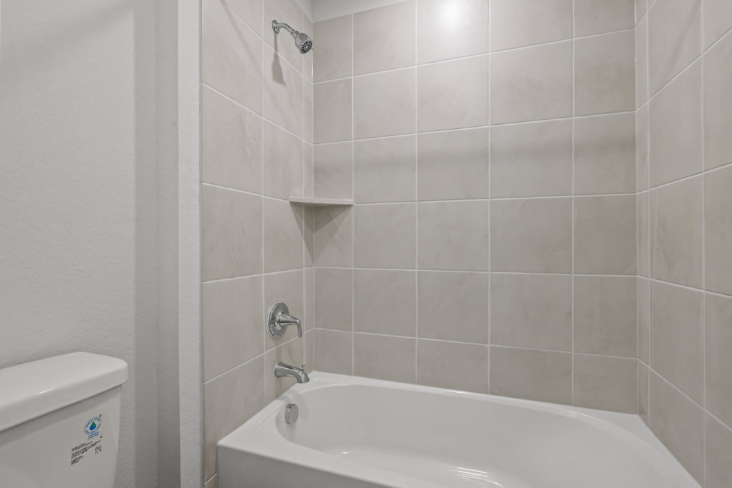 A bathtub in a bathroom.