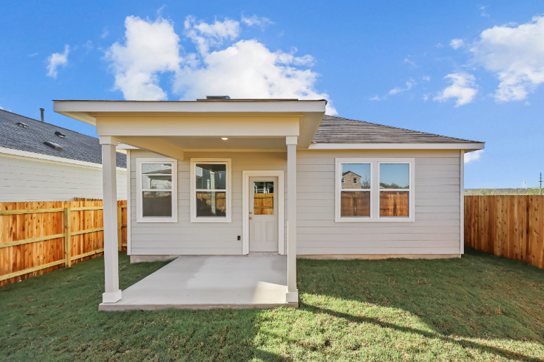 A house with a fence and a yard with a wood fence.