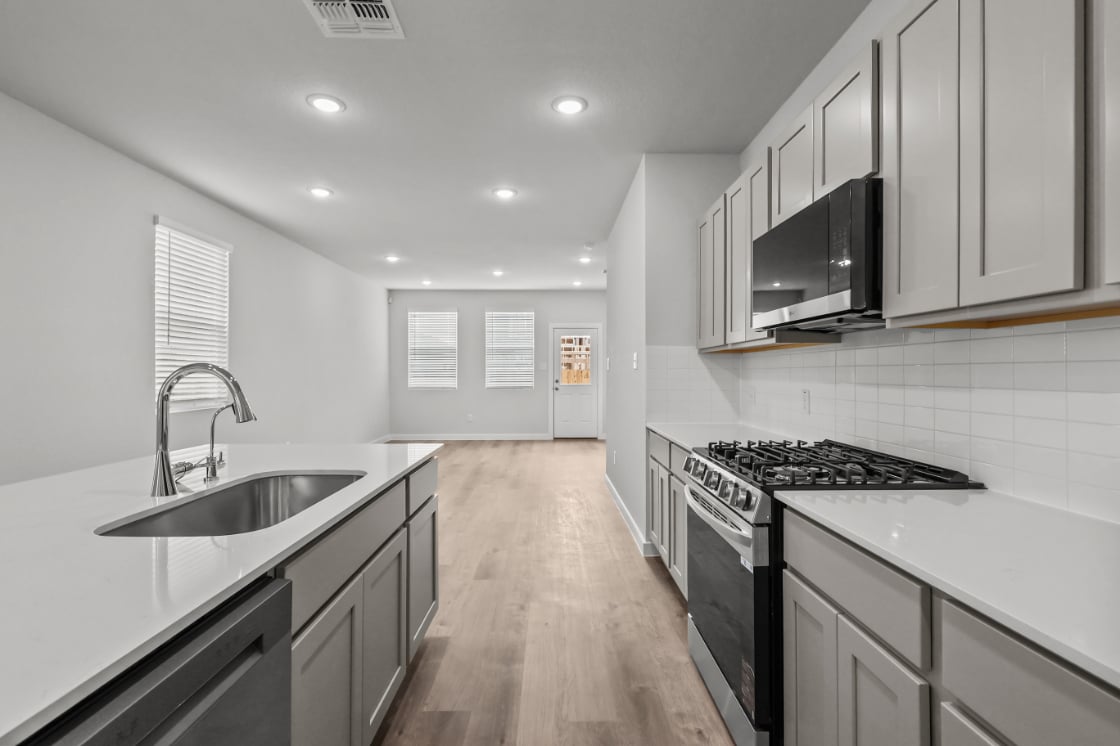 A kitchen with white cabinets.