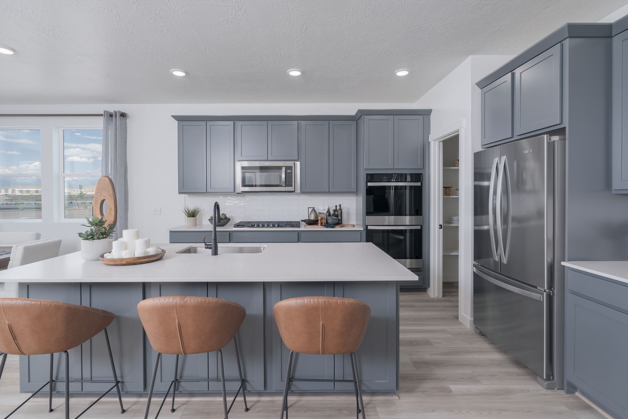 A kitchen with a table and chairs.