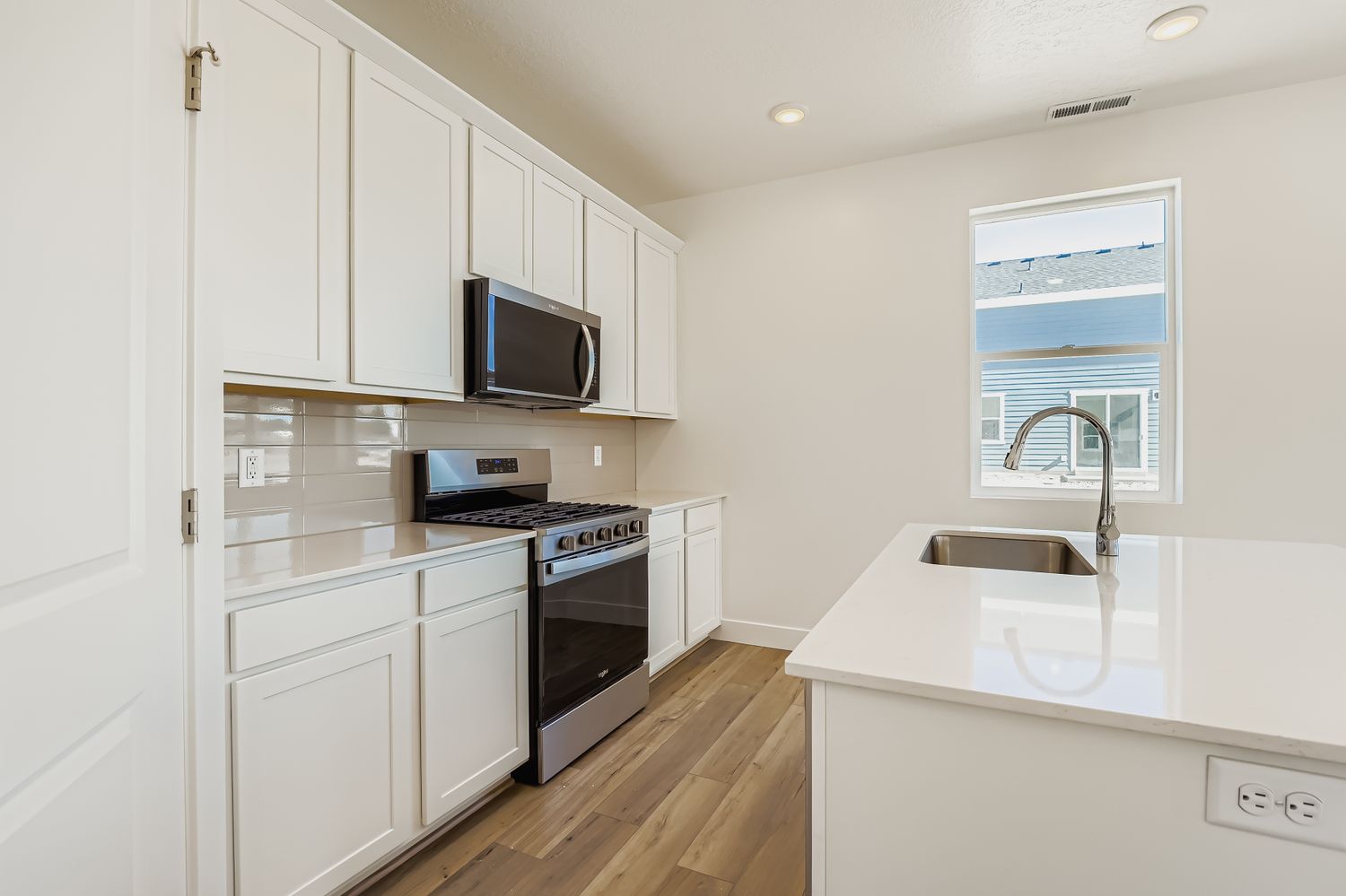 A kitchen with white cabinets.