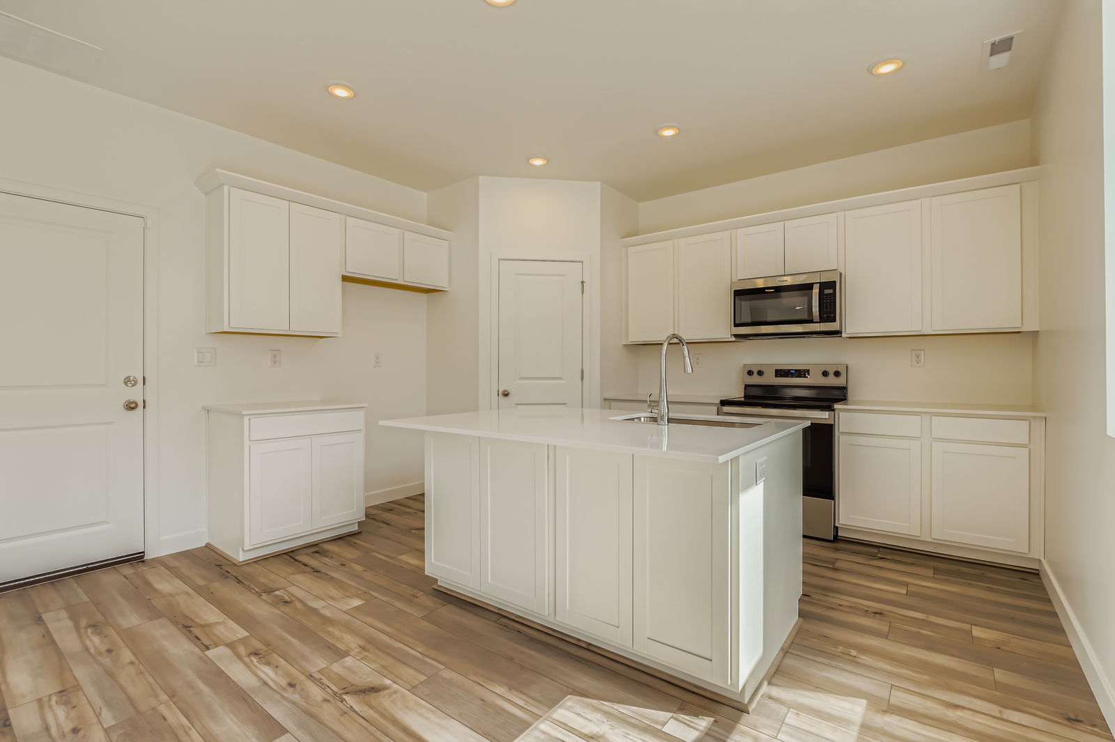A kitchen with white cabinets.