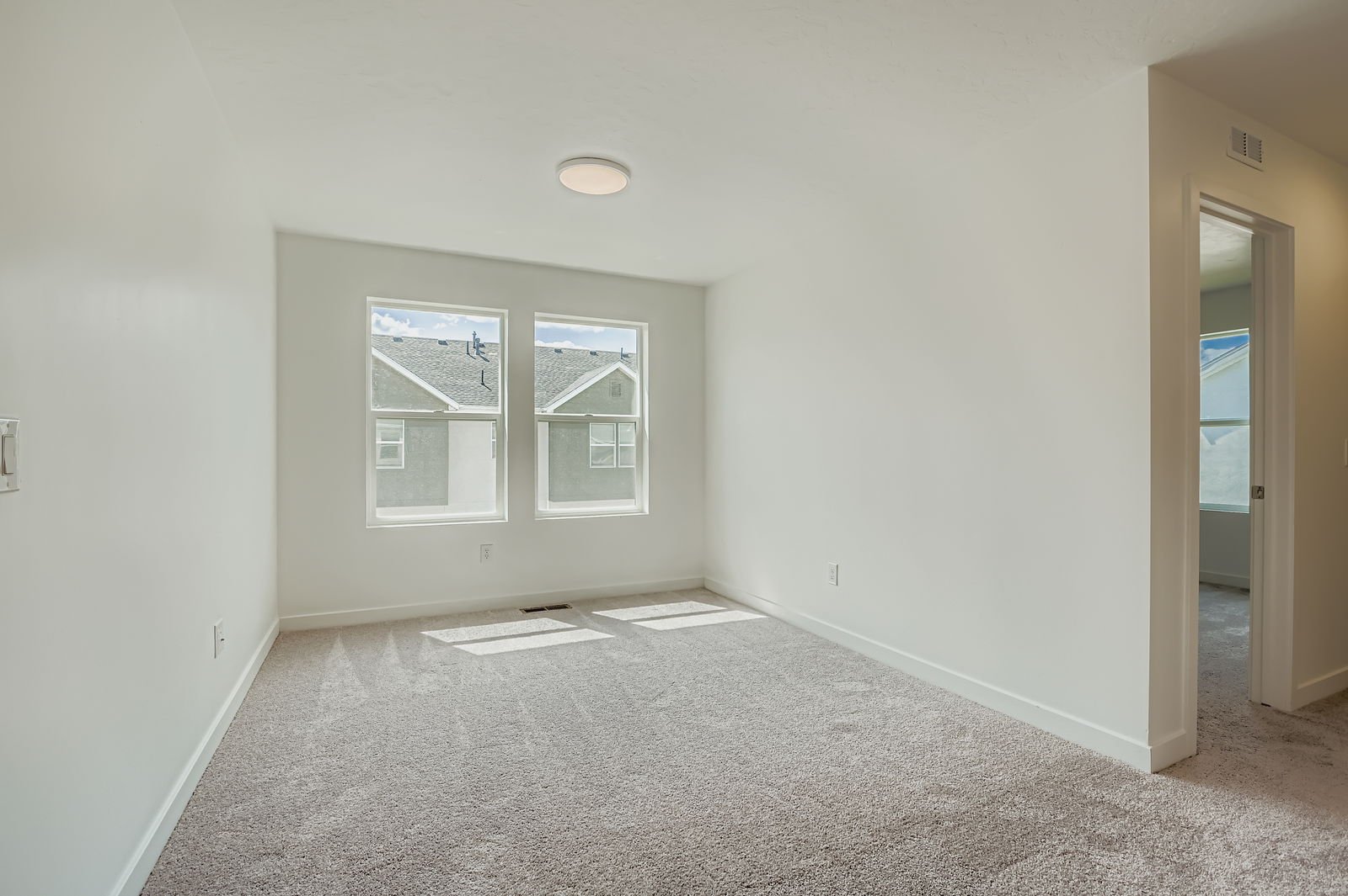 A room with a window and a carpet.