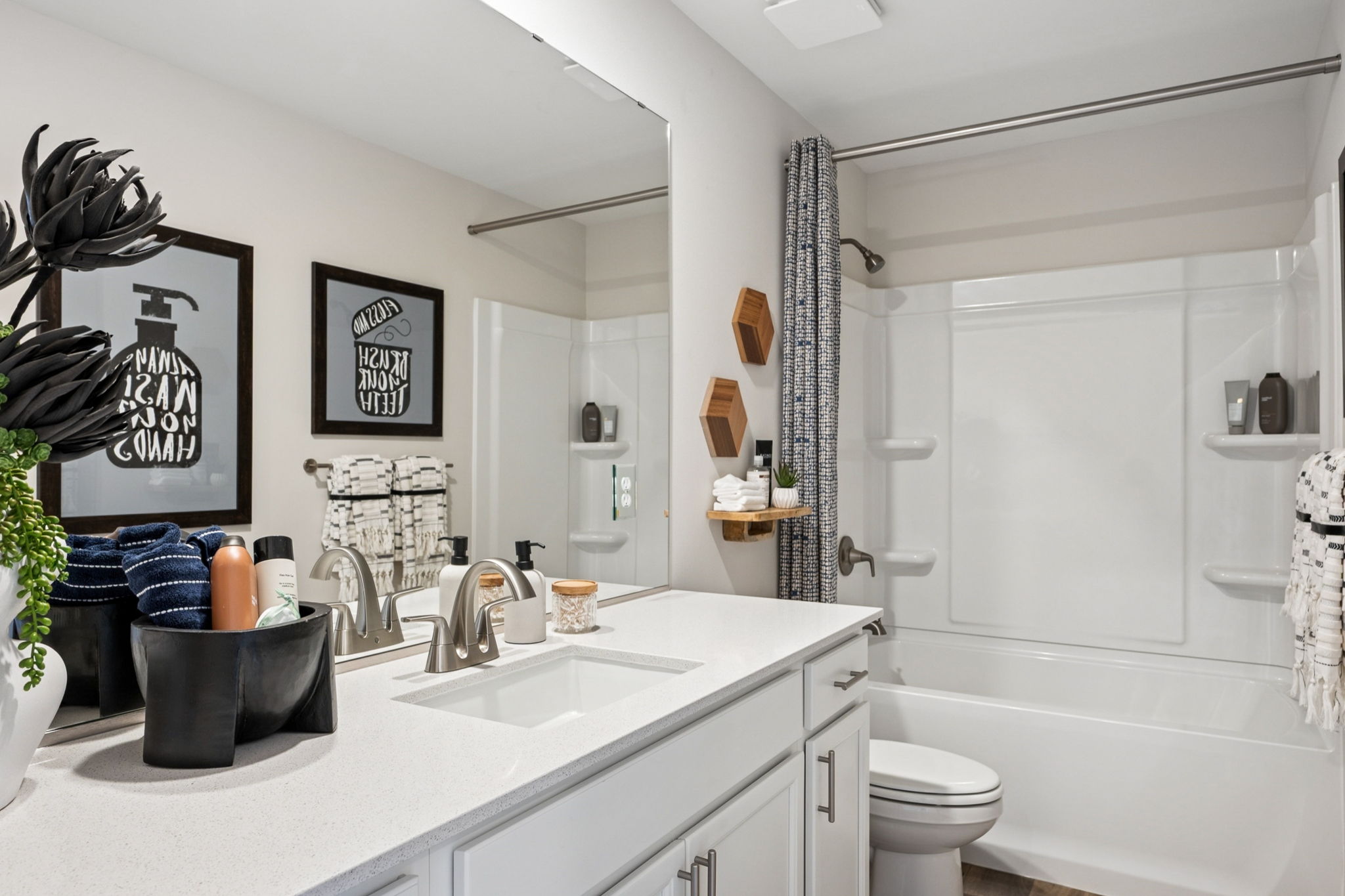A bathroom with a tub sink and toilet.
