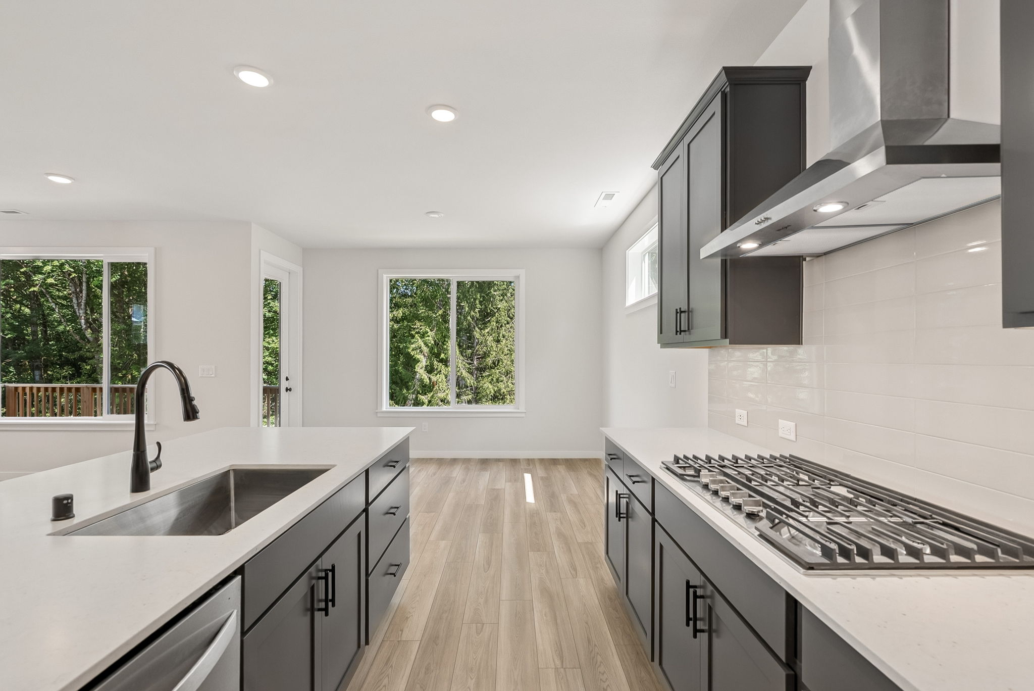 A kitchen with a stove and a sink.