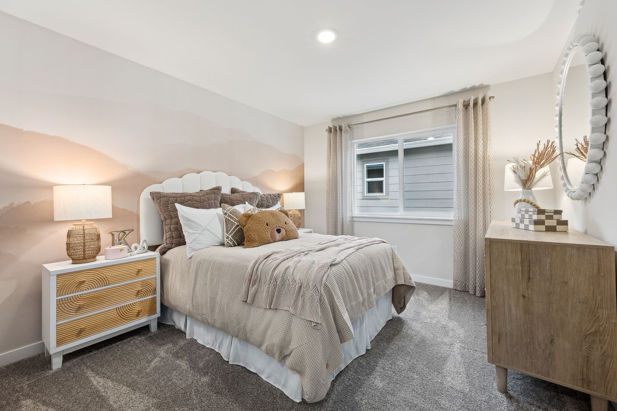 A bedroom with a bed and a dresser.