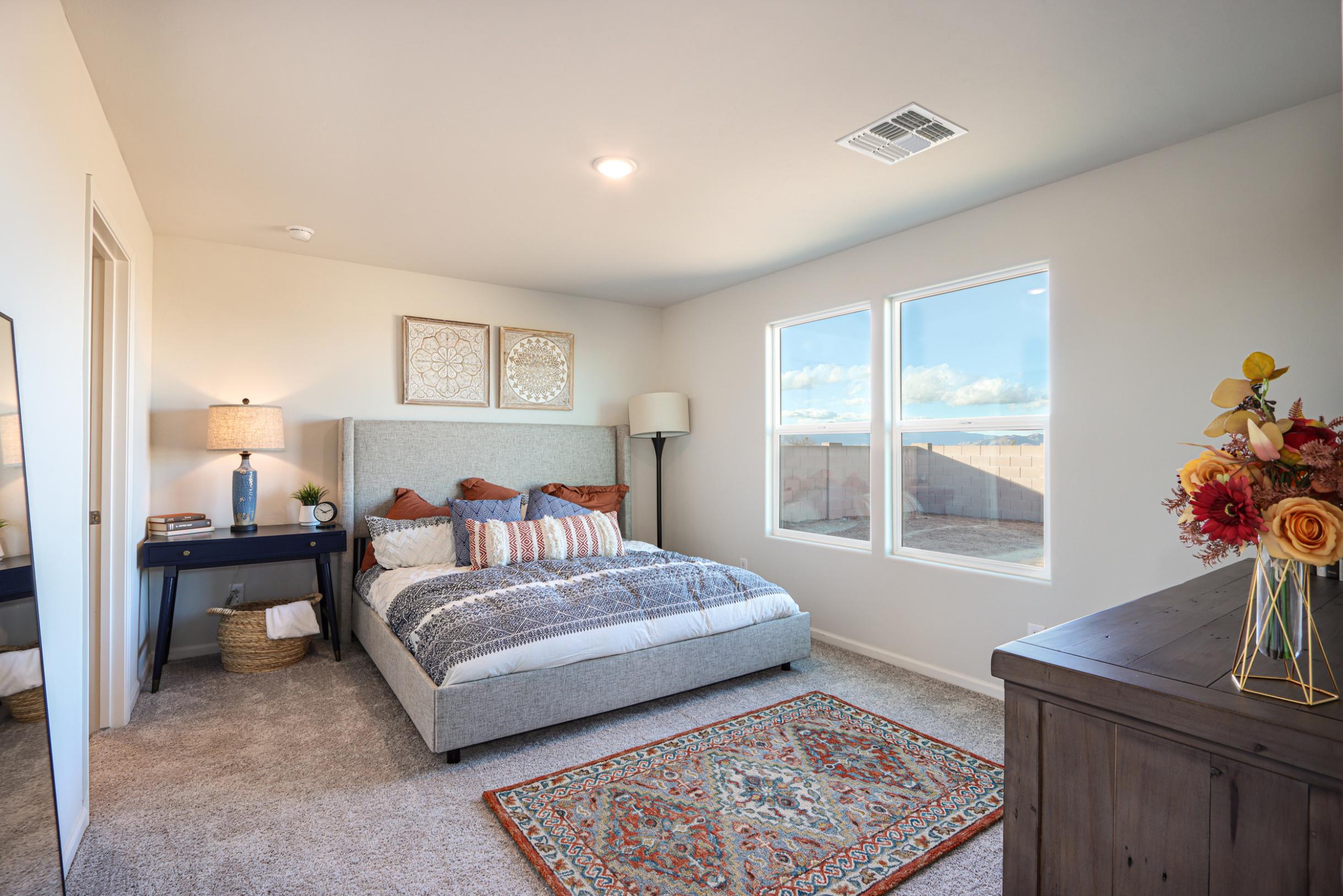 A bedroom with a large window.
