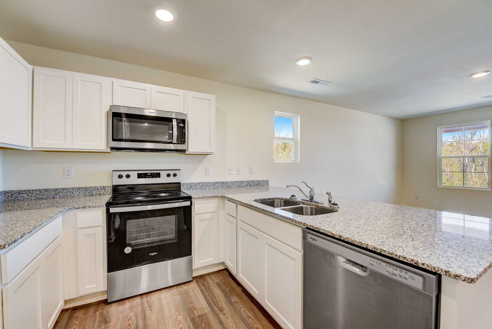 A kitchen with white cabinets.