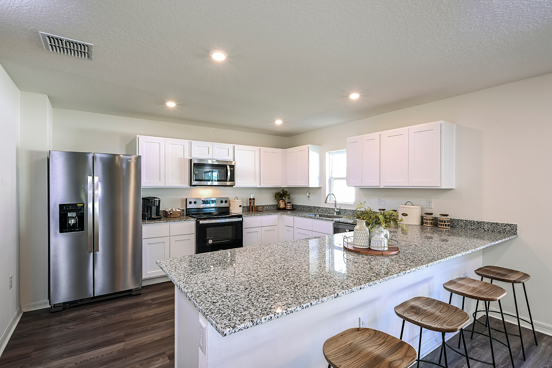 A kitchen with white cabinets.