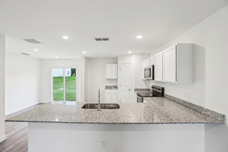 A kitchen with marble counters.