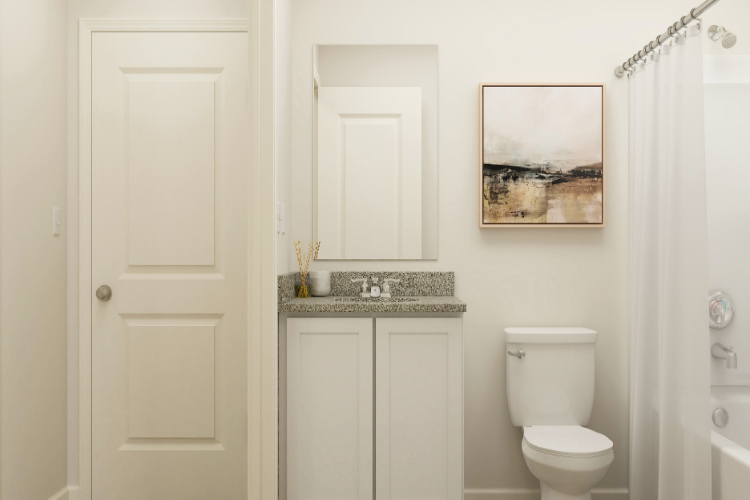 A bathroom with a sink toilet and a shower.