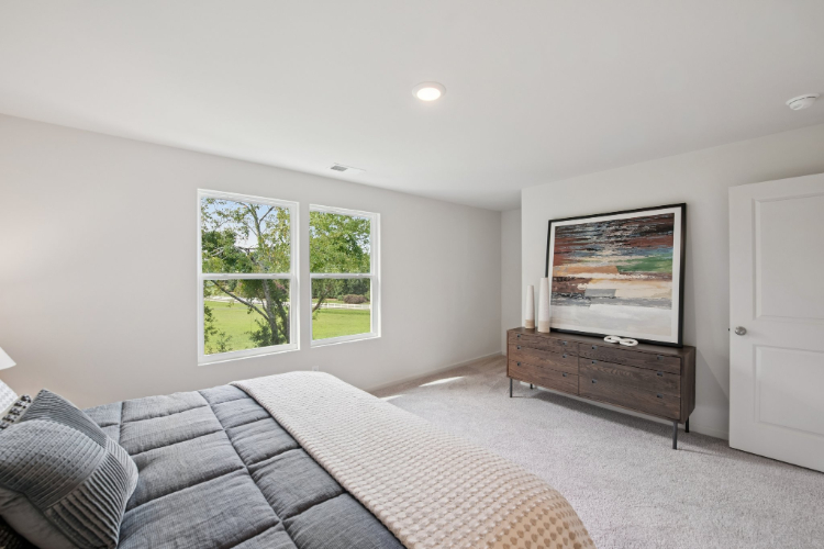 A room with a bed and a window.