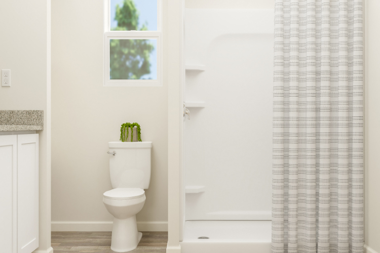 A bathroom with a toilet and shower.