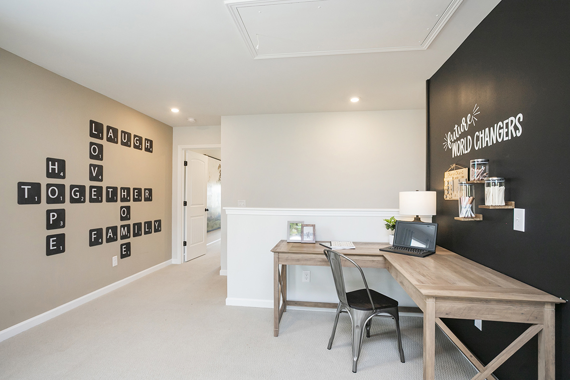 A room with a desk and a laptop.