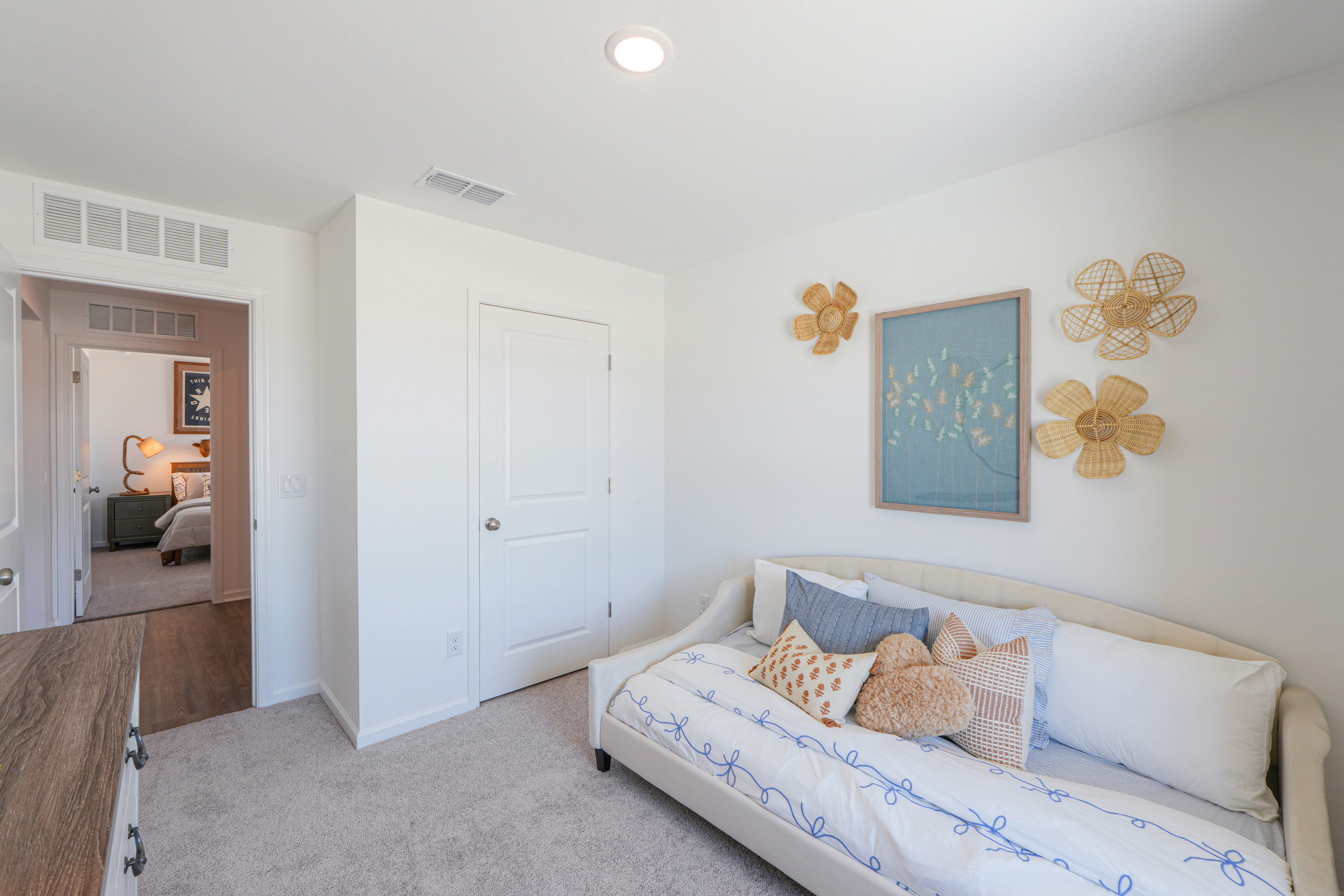 A room with a couch and a mirror.