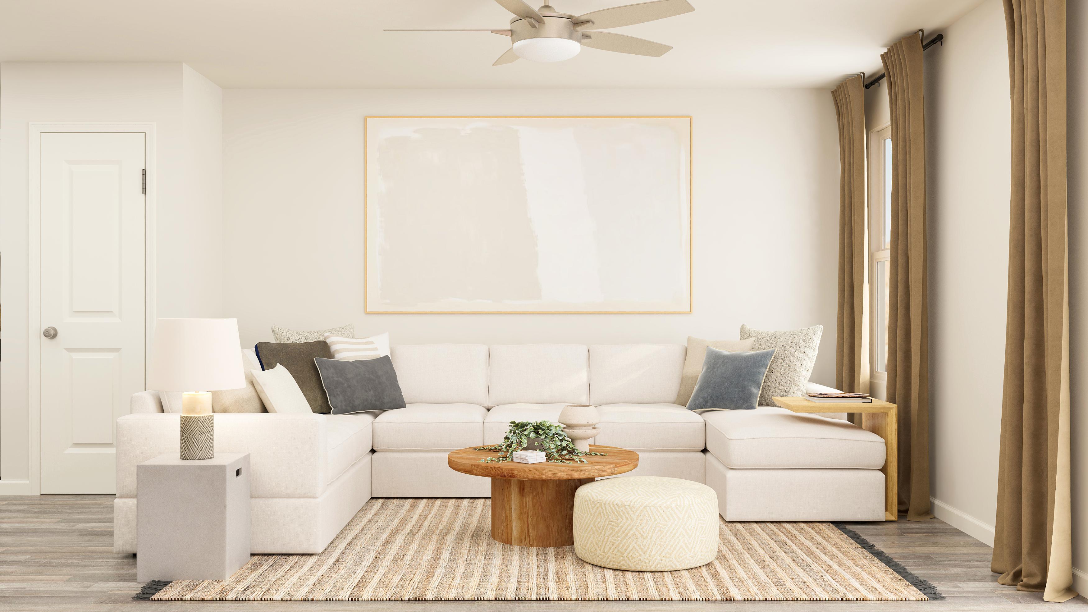 A living room with a white couch and a white ceiling fan.