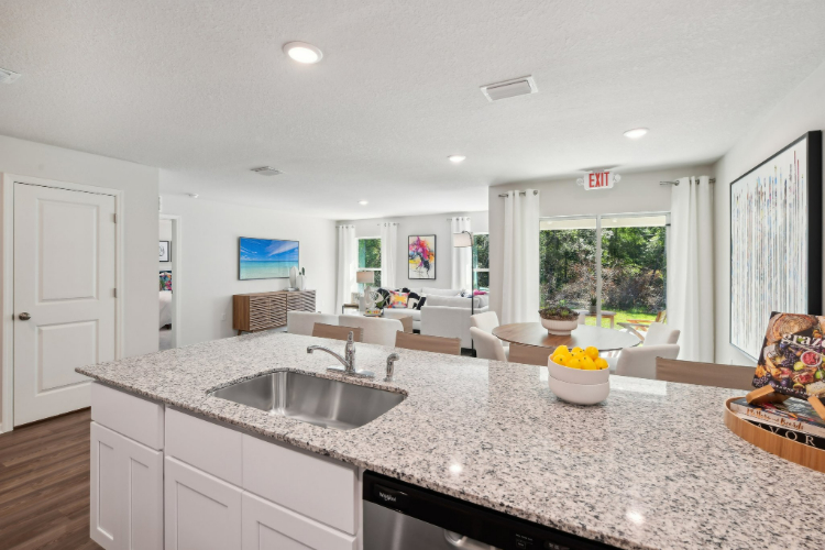 A kitchen with a marble counter top.