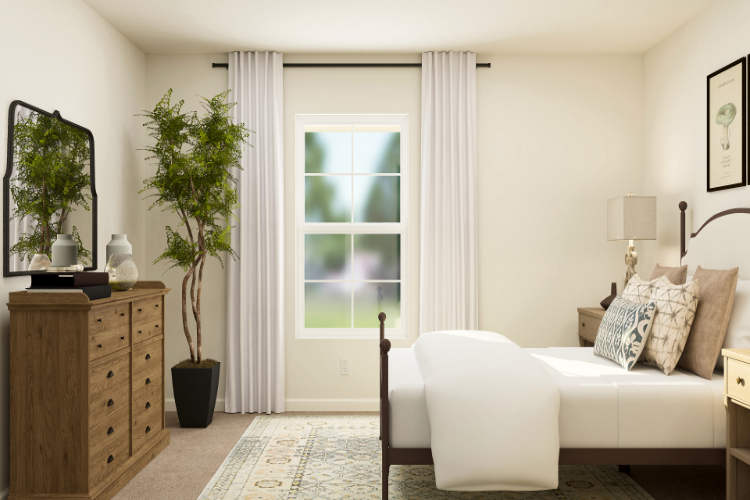 A room with a couch and a table with a plant in it.