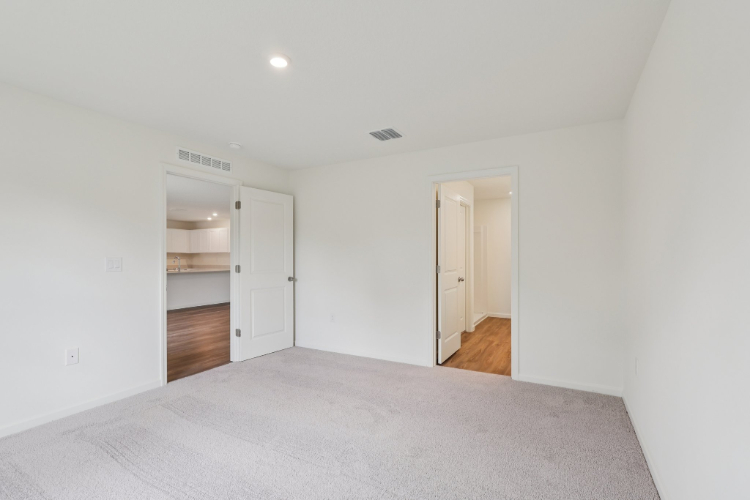 A room with a bed and a door.