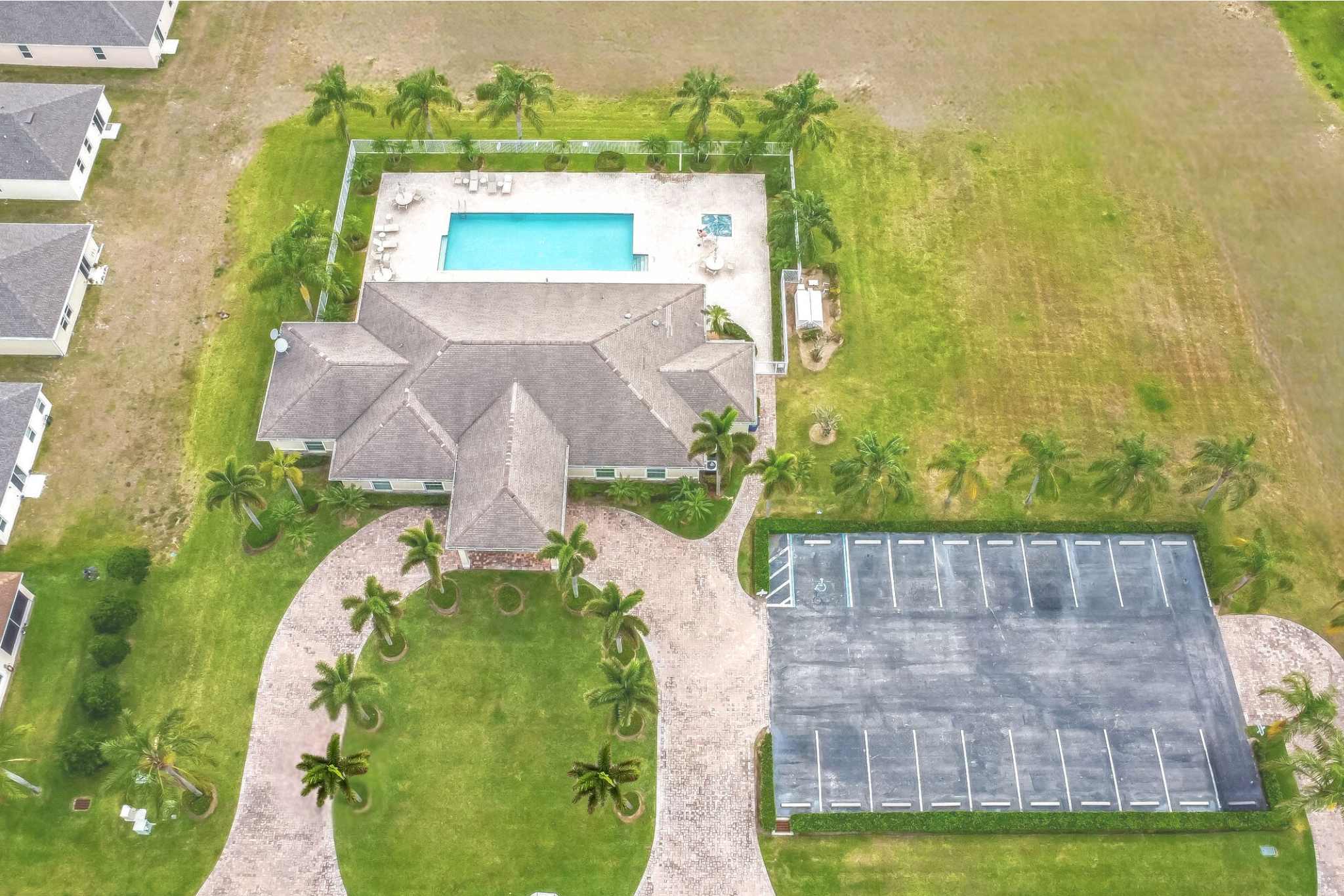 A building with a pool in the middle of a field.